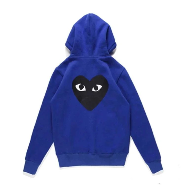 There is a big black heart behind the velvet blue cardigan